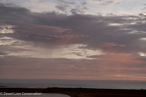 Cloud build-up and sheets of light rain at the mouth of the Hoanib river.